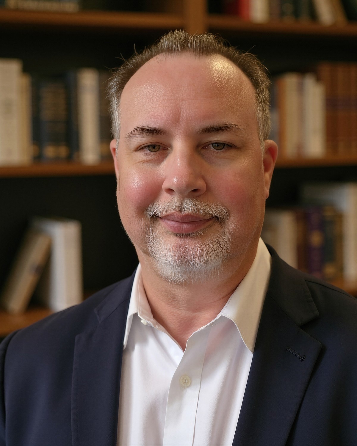 Jason, founder of Blackburn Retirement Strategies, standing in front of a bookshelf.